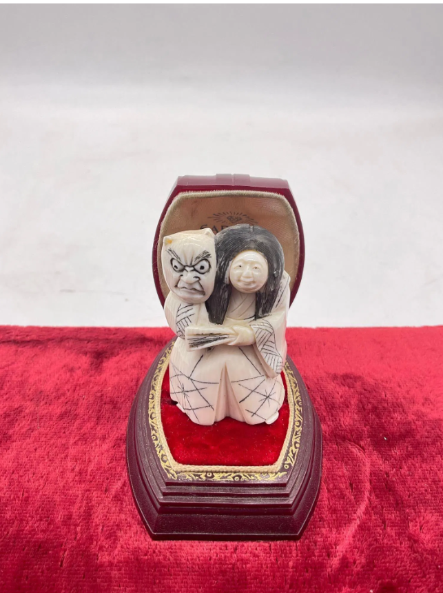 A carved Japanese figurine made out of elephant ivory.